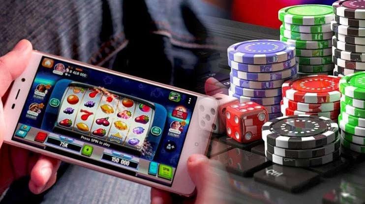 Close up tangan memegang ponsel yang memperlihatkan opsi hiburan casino digital fokus77